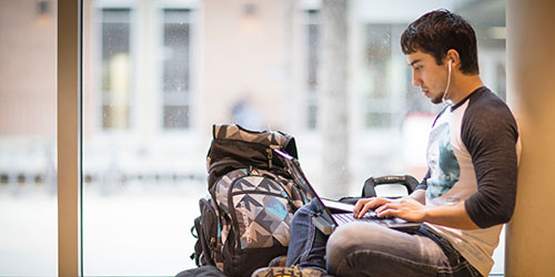 male student using laptop