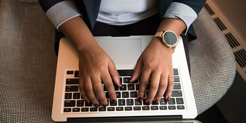 woman typing on laptop